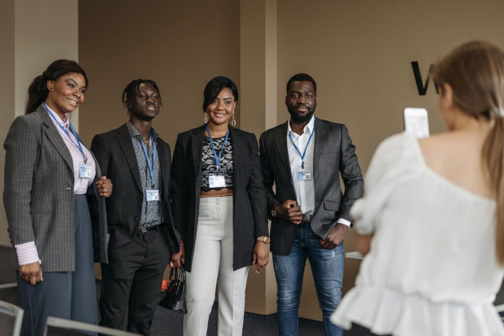 A diverse group of professionals poses together during a business conference for a memorable group photo.